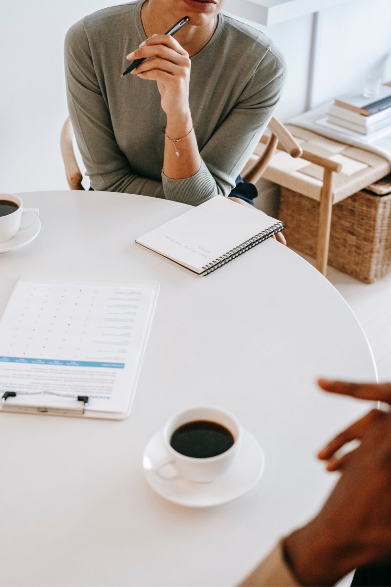 Notebook and coffee on a meeting table