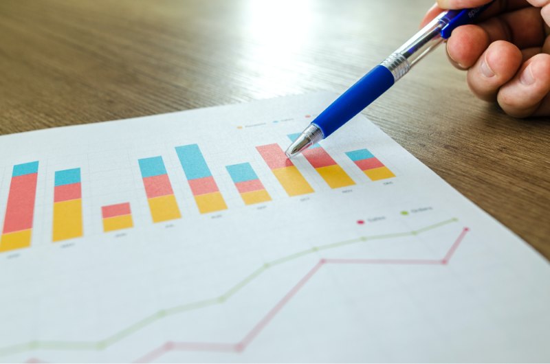 Analyst marking up a printed bar chart